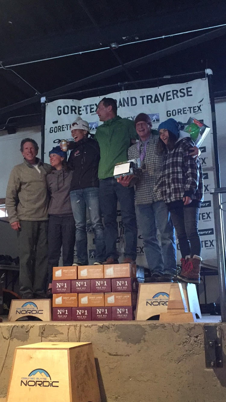 Grand Traverse winners standing on the Upslope can podium.